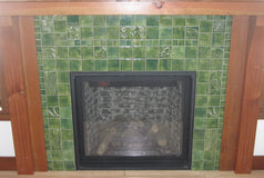 Crafting Nature: A Hearth with Green Handmade Tiles and Natural Woodwork