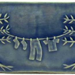 clothesline art tile with blue glaze